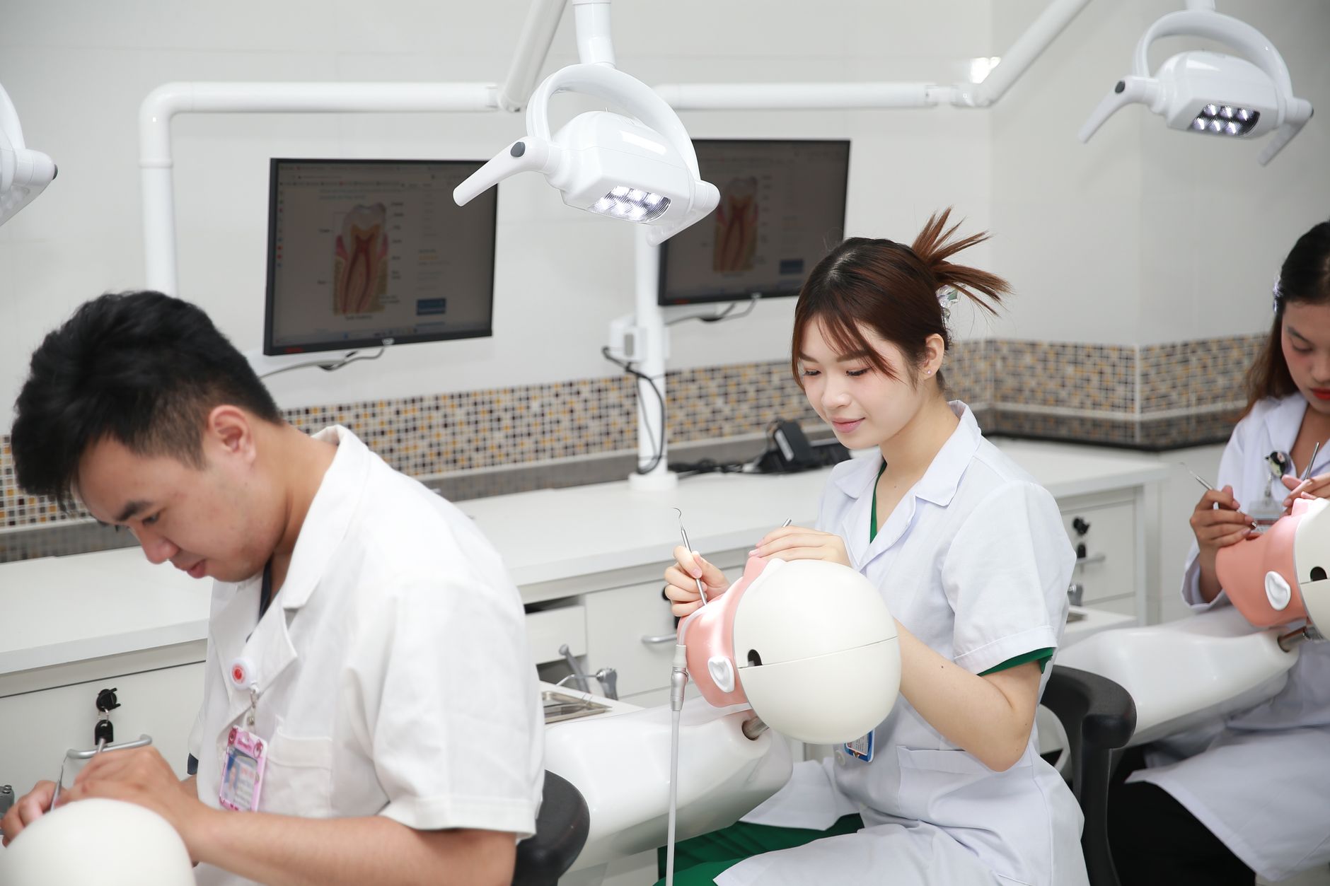Students practicing dental procedures on training models